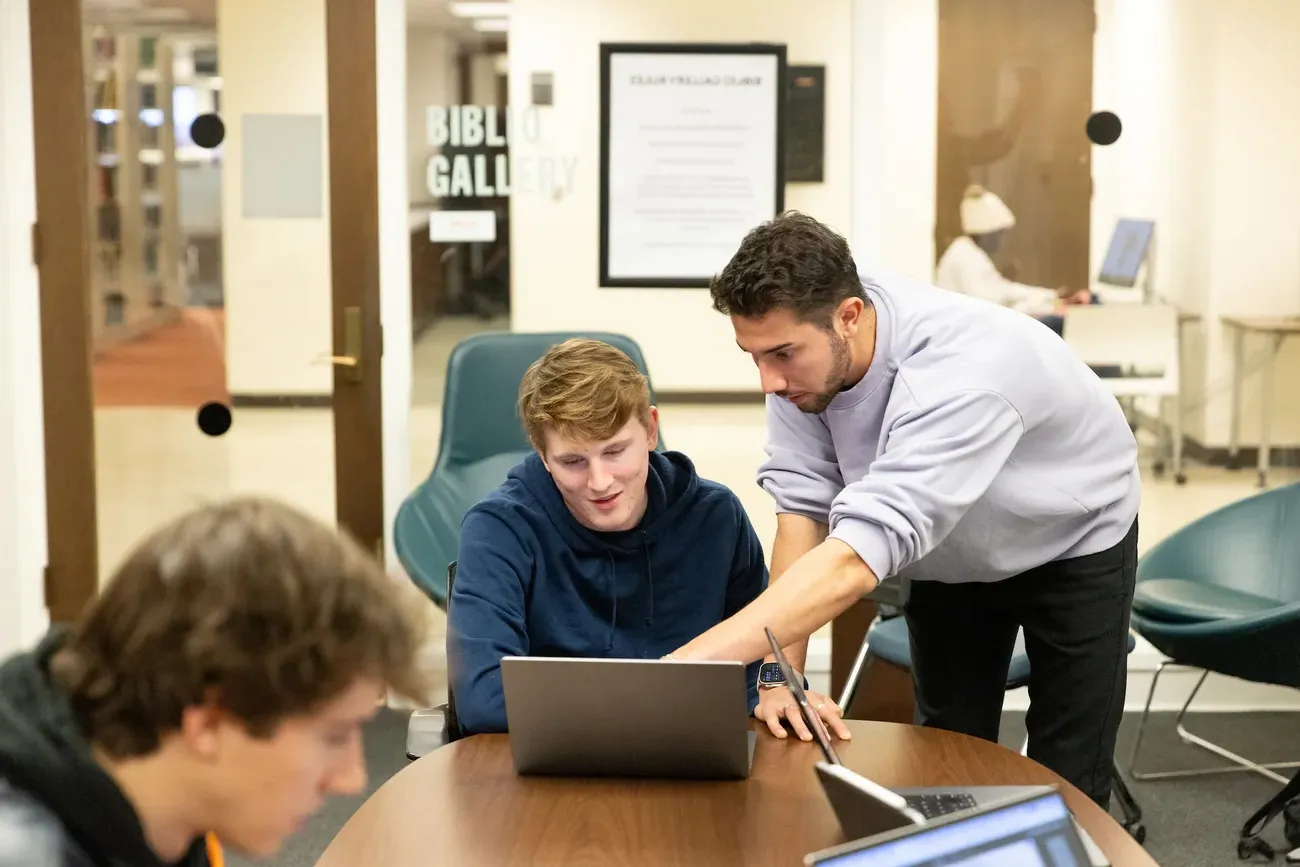 Students looking at a computer.