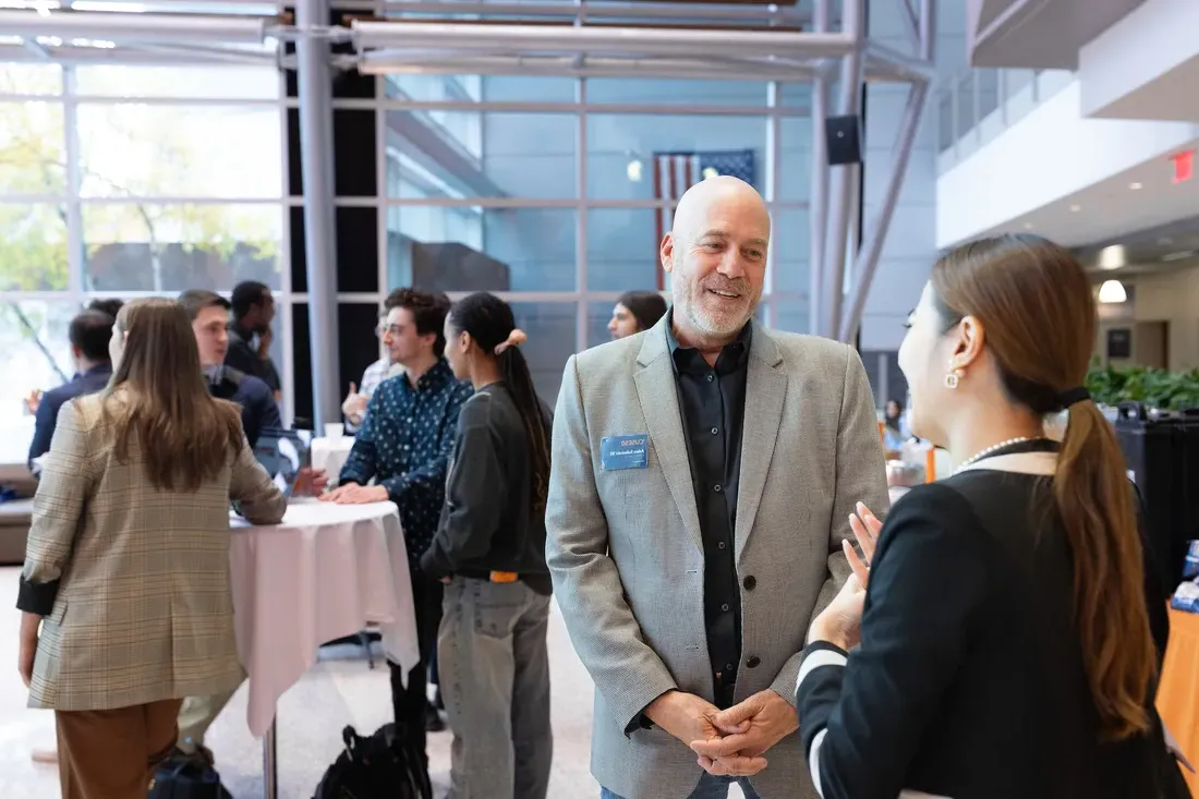 A student with an alum at a networking event.