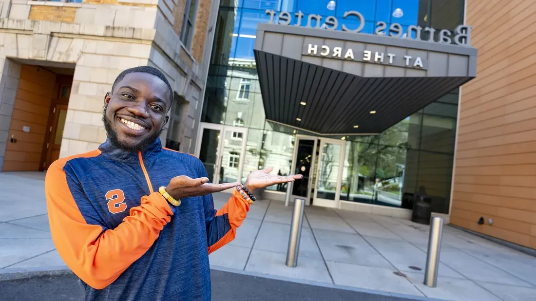 Kelvin Boakye '24 standing outside the Barnes Center at The Arch smiling.